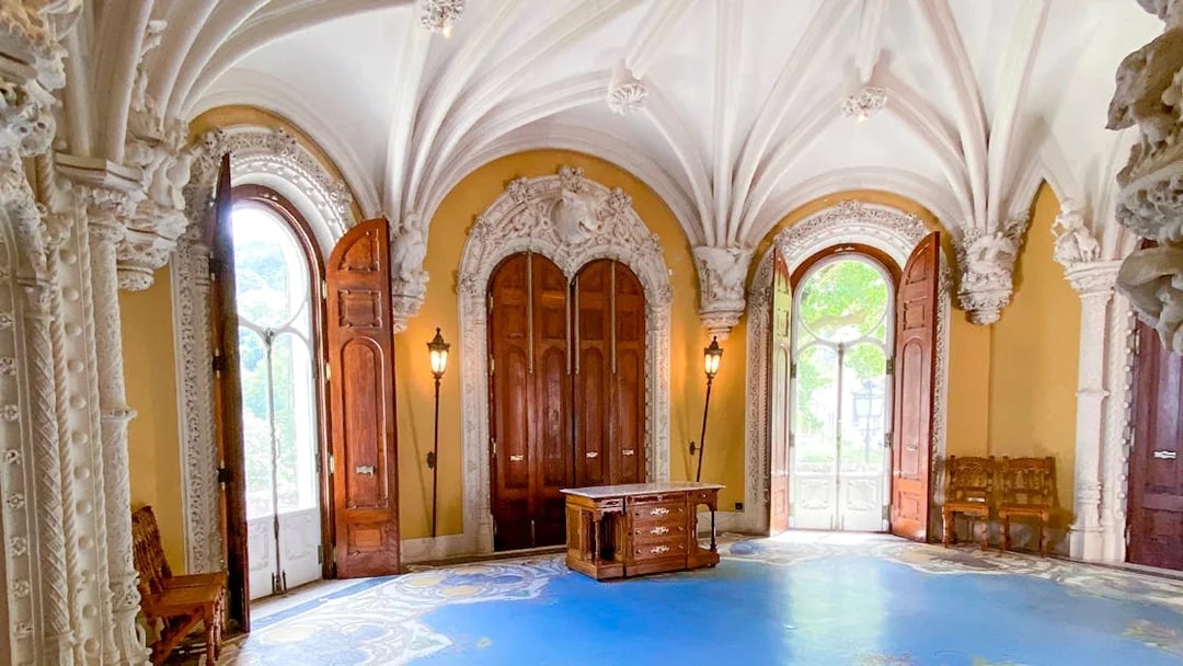 Quinta da Regaleira ornate room with arched ceiling and wooden doors in Sintra, Portugal.