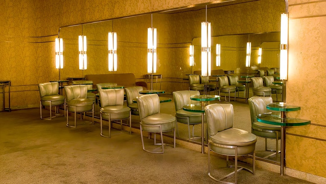 Art Deco lounge area at Radio City Music Hall with mirrored walls and vintage seating.