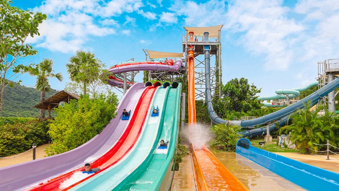 Water slides at Ramayana Water Park with people enjoying rides.