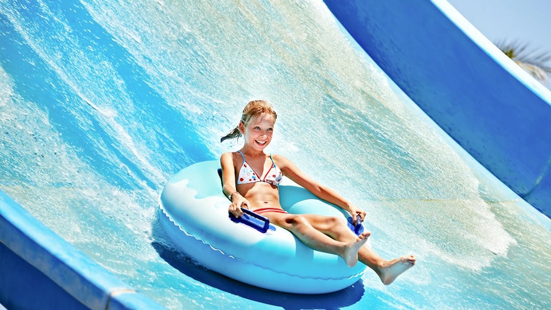 Child enjoying a water slide at Ramayana Water Park.