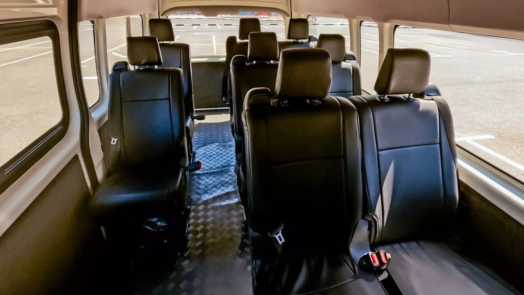 Interior of a shuttle bus for Aquaventure Waterpark transport service.