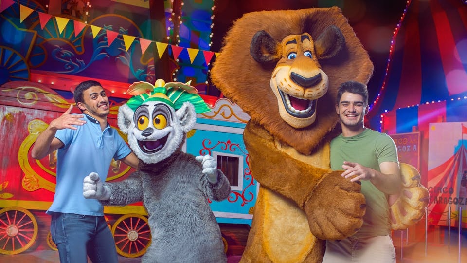 Guests posing with Madagascar characters at Dubai Parks and Resorts.