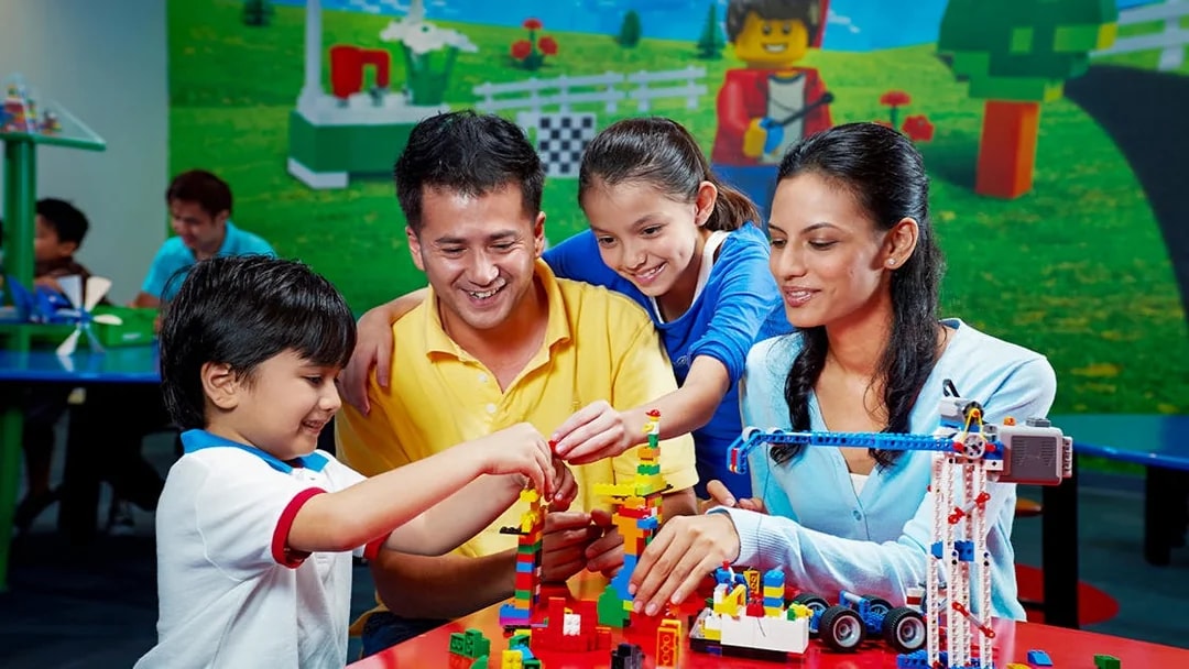 Children building with Lego bricks at Legoland Dubai.