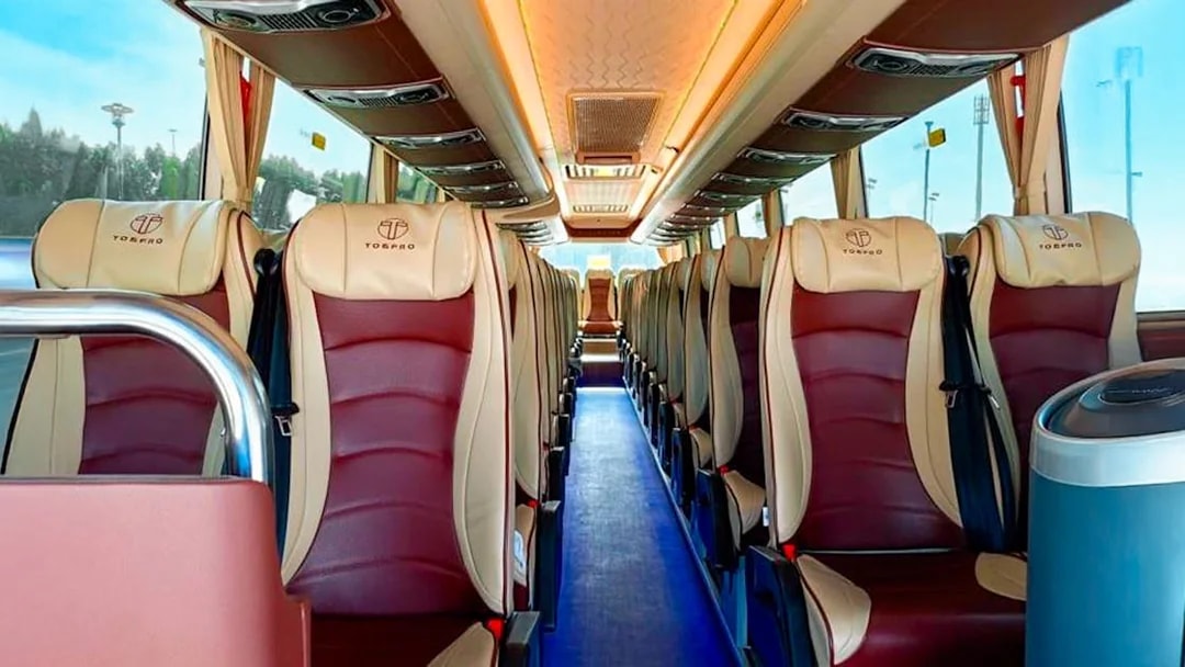 Interior of a tour bus with comfortable seating for Aquaventure Waterpark visitors.
