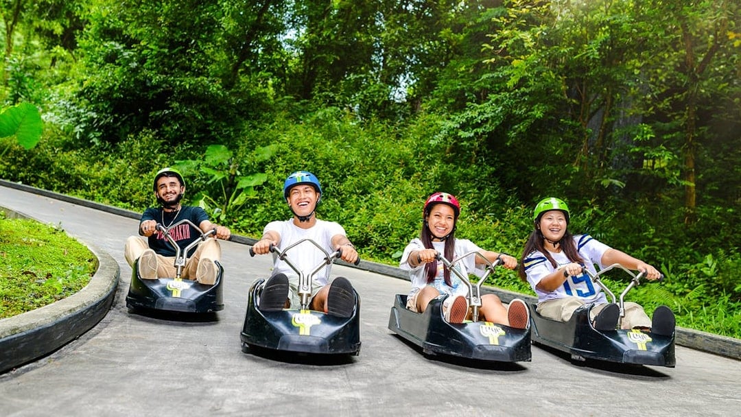 Friends enjoying a ride on the Skyline Luge track in Singapore.