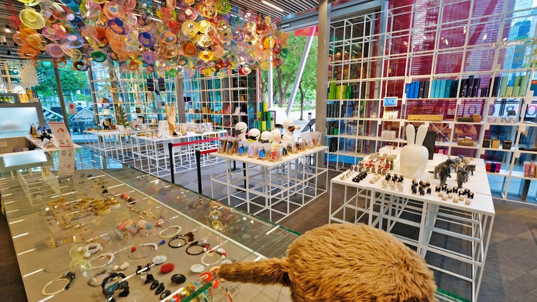 Red Dot Design Museum interior with colorful ceiling art and display of unique gifts in Singapore.
