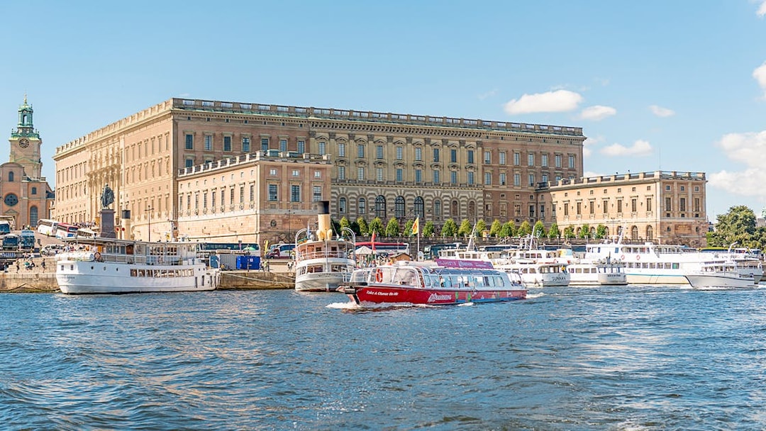 Stockholm hop-on hop-off boat near the Royal Palace on a sunny day.