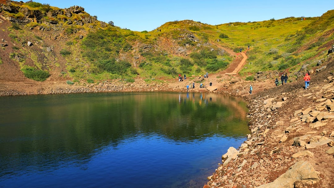 Kerid Crater with visitors walking along the path, part of the Golden Circle tour from Reykjavik.