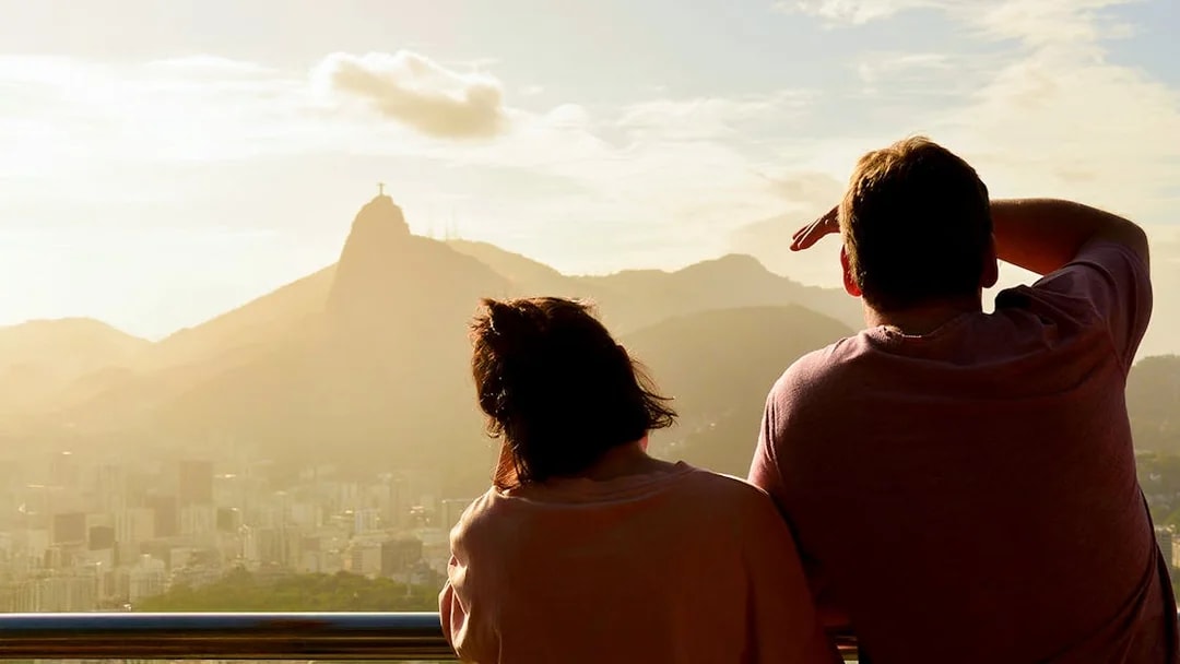 Couple viewing Christ the Redeemer from Sugarloaf Mountain, Rio de Janeiro.