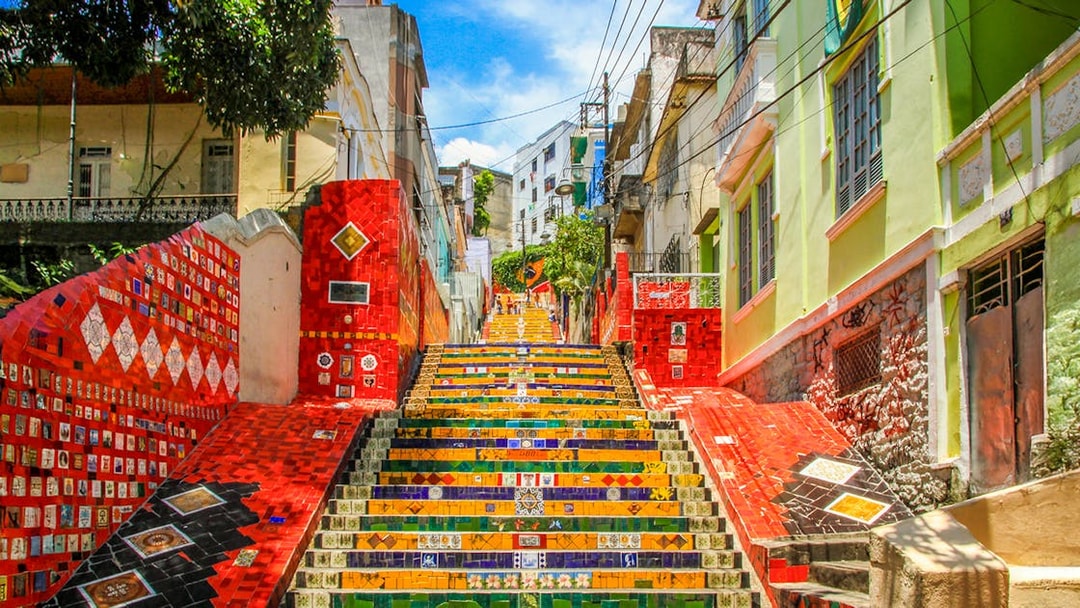 Escadaria Selarón in Rio de Janeiro, vibrant mosaic-tiled steps ascending between colorful buildings.