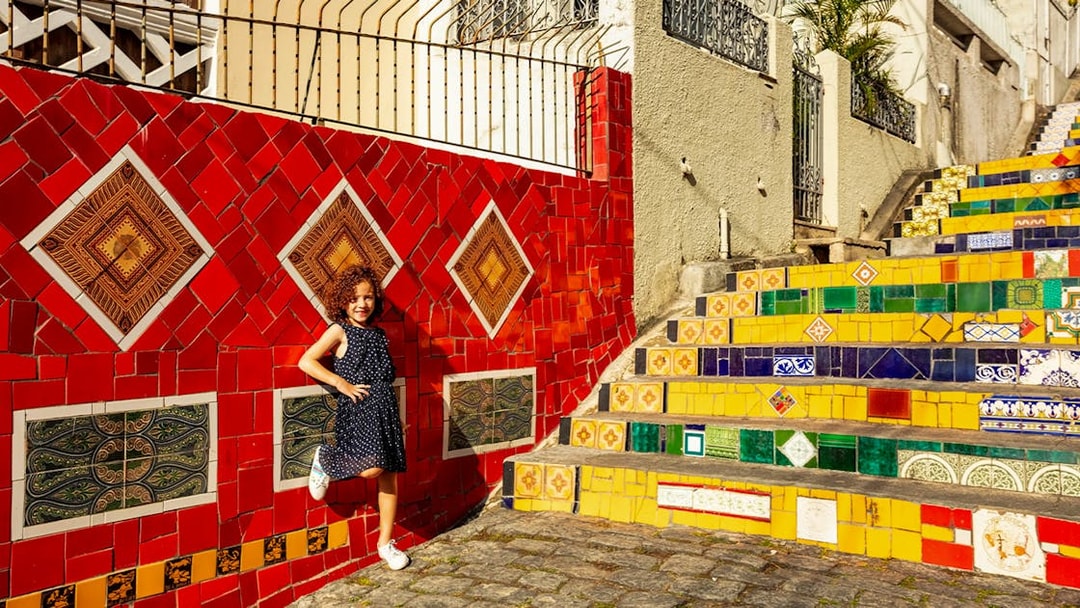 Child posing on colorful Selarón Steps in Rio de Janeiro.
