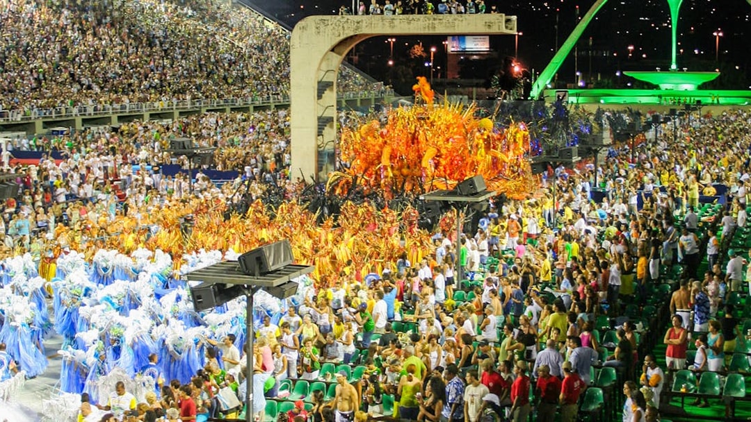 Sambadrome parade with colorful costumes and full grandstands in Rio de Janeiro.
