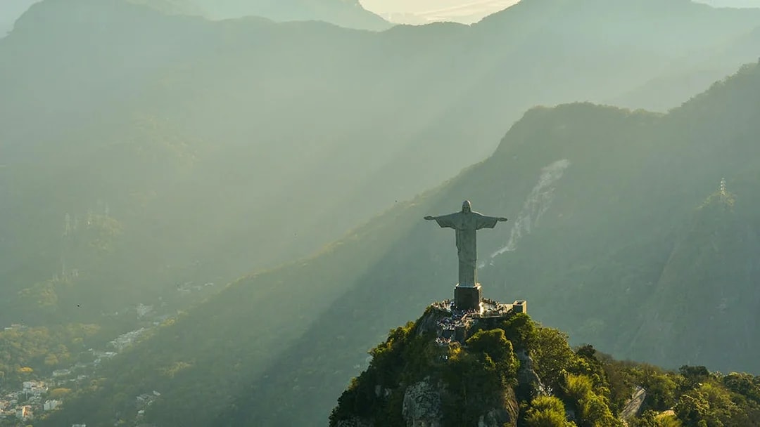 Aerial view of Christ the Redeemer statue in Rio de Janeiro during morning light.