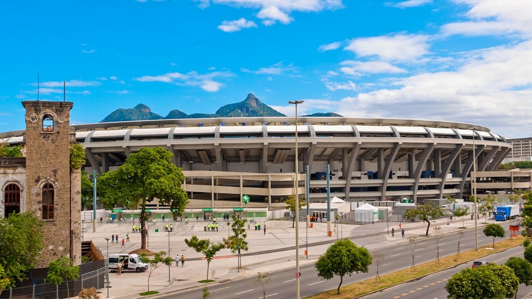 Maracanã Stadium in Rio de Janeiro with distant mountain view.