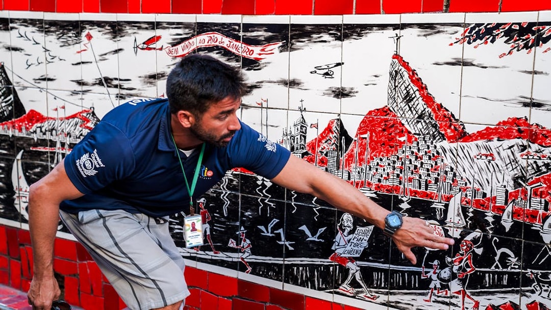 Tour guide explaining artwork on Selarón Steps in Rio de Janeiro.