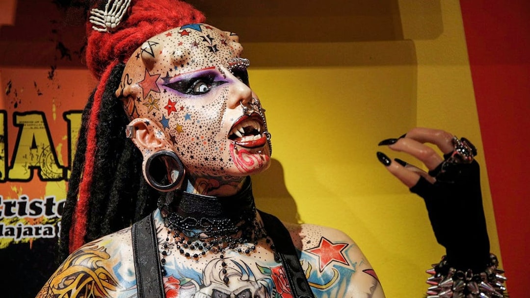 Tattooed figure with piercings and colorful designs at Ripley’s Adventureland.