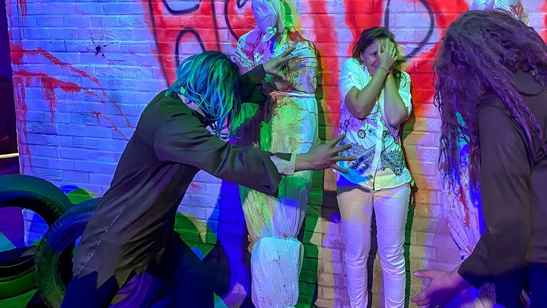 Visitors experiencing a haunted attraction at Ripley’s Adventureland.