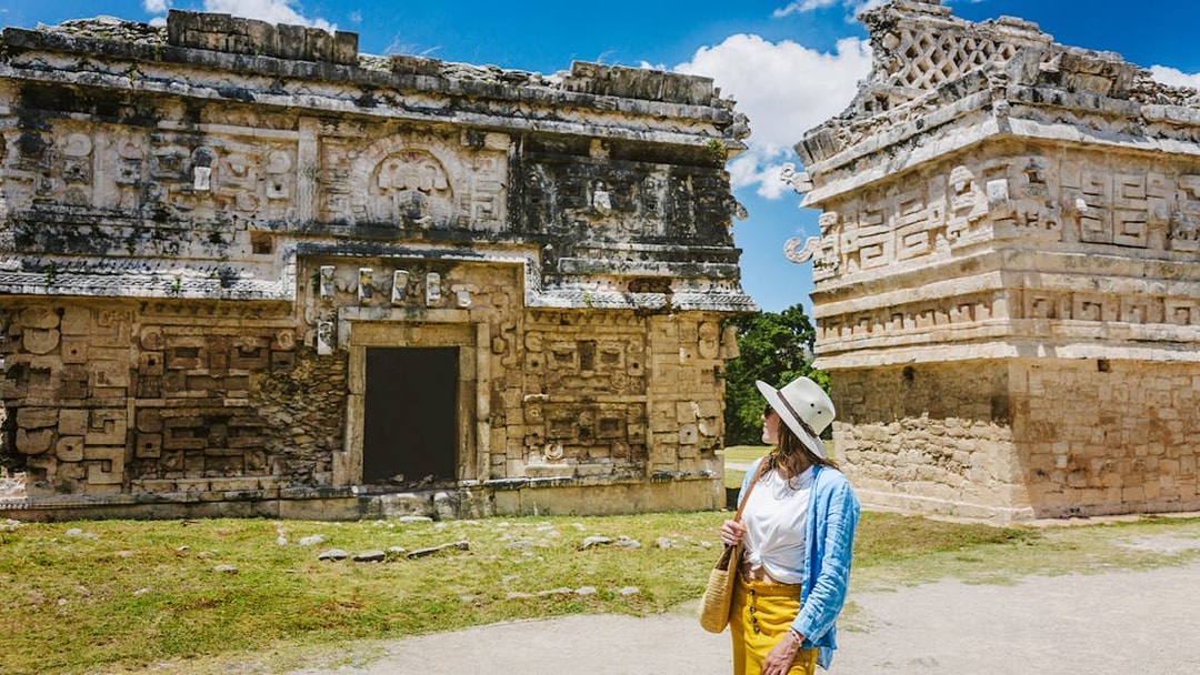 Tourist exploring ancient ruins at Chichen Itza, Yucatan.