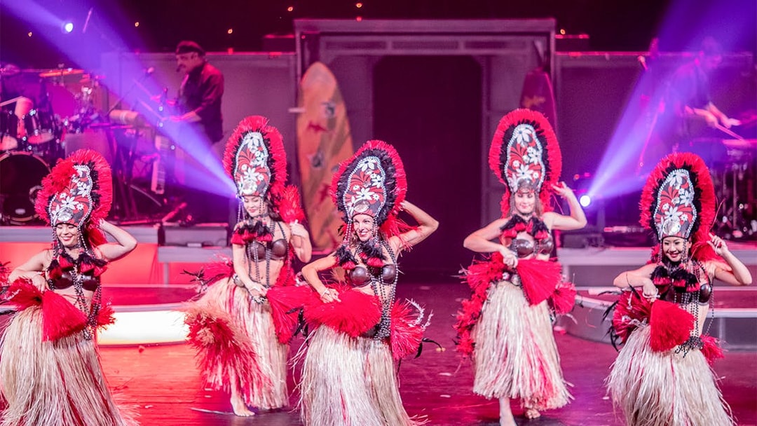 Dancers performing in traditional costumes at Rock-A-Hula Show in Honolulu.