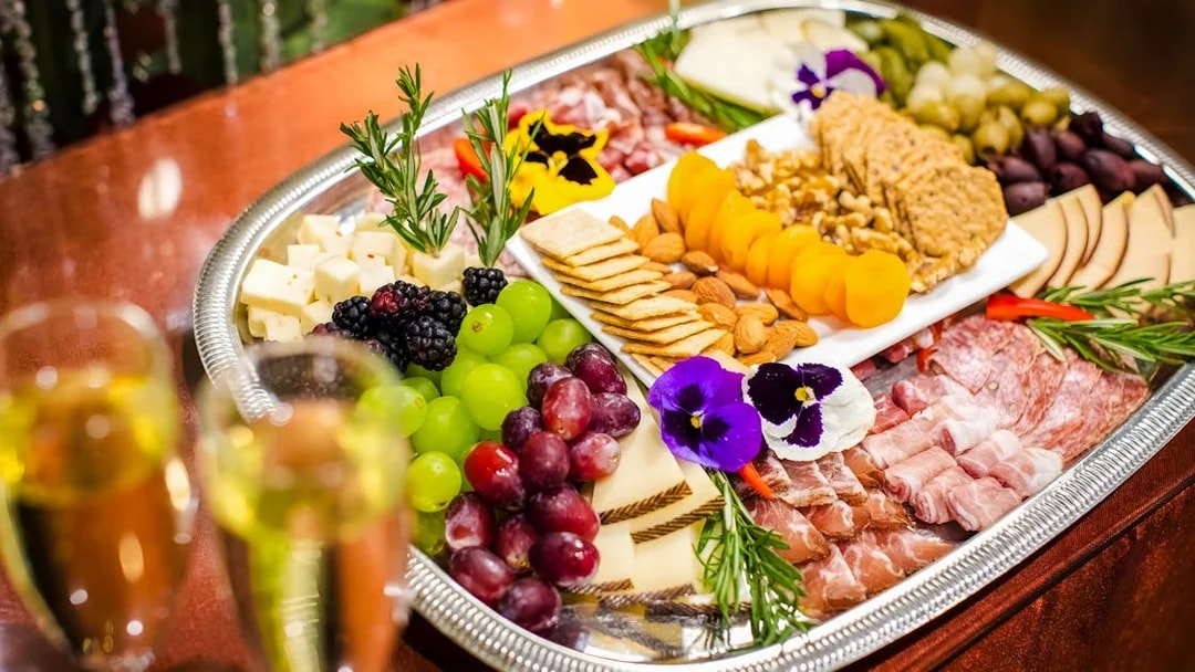 Cheese and charcuterie board with fruits and nuts at Waikiki Luau, Honolulu.