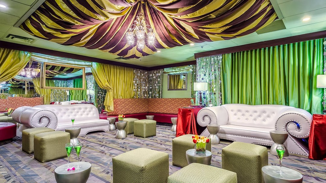 Luxurious seating area in the Green Room at Rock-A-Hula show with elegant decor and lighting.