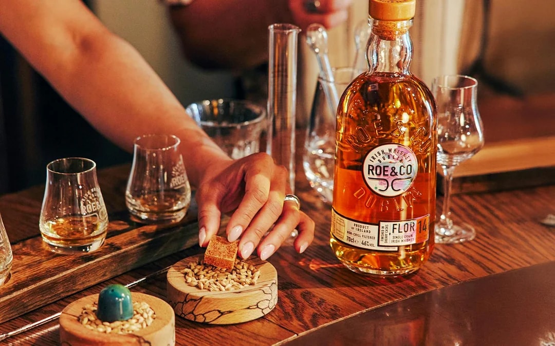 Roe & Co Distillery whiskey tasting setup with glasses and ingredients.