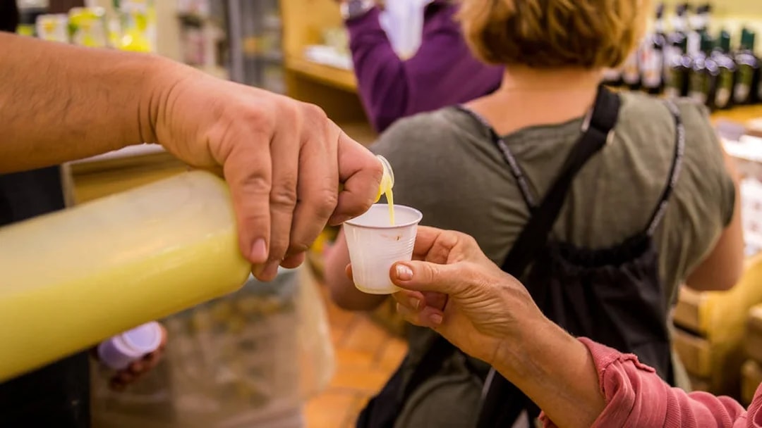 Pouring limoncello sample during Amalfi and Positano tour from Rome.