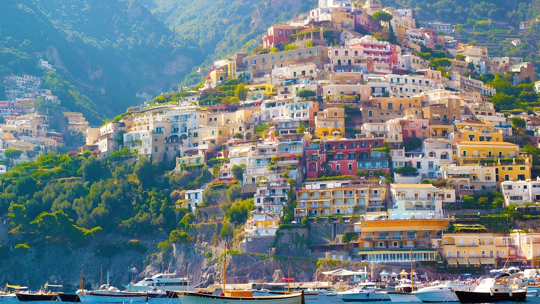 Colorful hillside buildings in Positano, Italy, viewed from the sea, part of the Amalfi Coast tour from Rome.