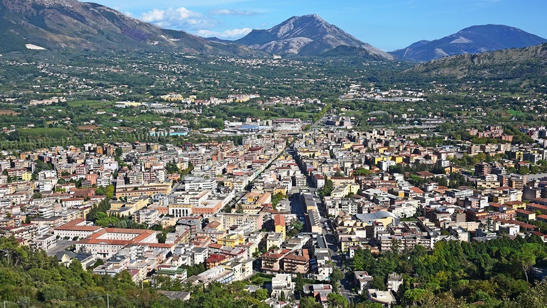 Aerial view of a town with mountains in the background on the Amalfi & Positano tour from Rome.