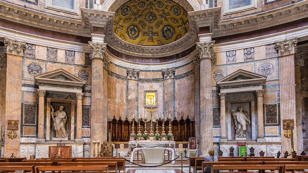 Pantheon altar in Rome with ornate columns and religious statues.