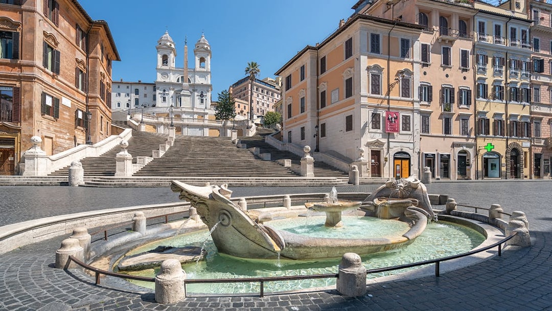 Spanish Steps in Rome with Barcaccia Fountain in foreground.