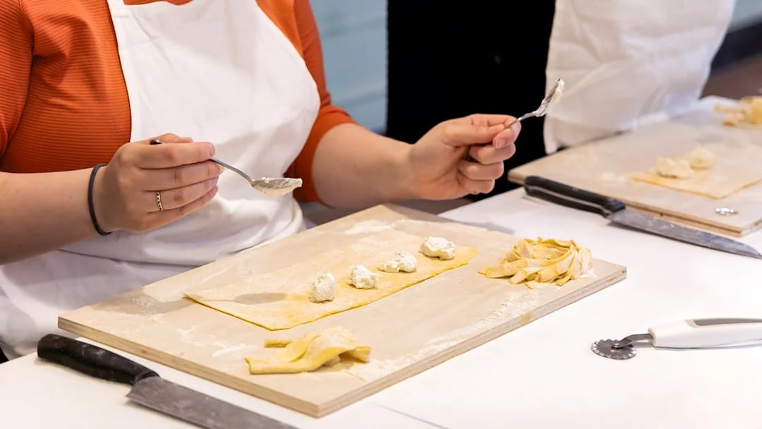Person preparing ravioli during a cooking class in Rome near Piazza Navona.