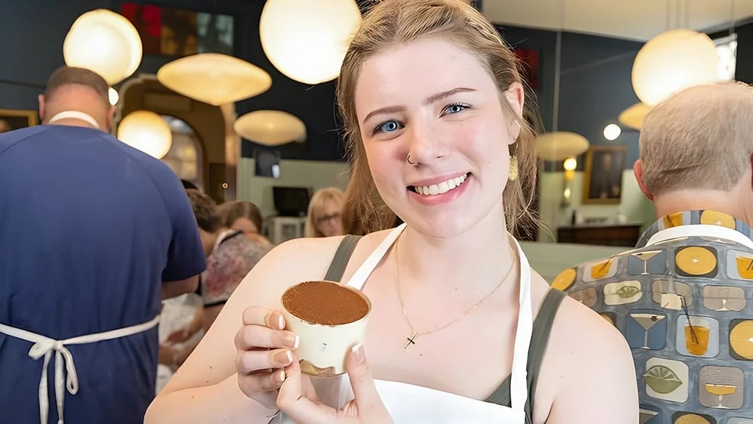 Cooking class participant holding tiramisù near Piazza Navona, Rome.