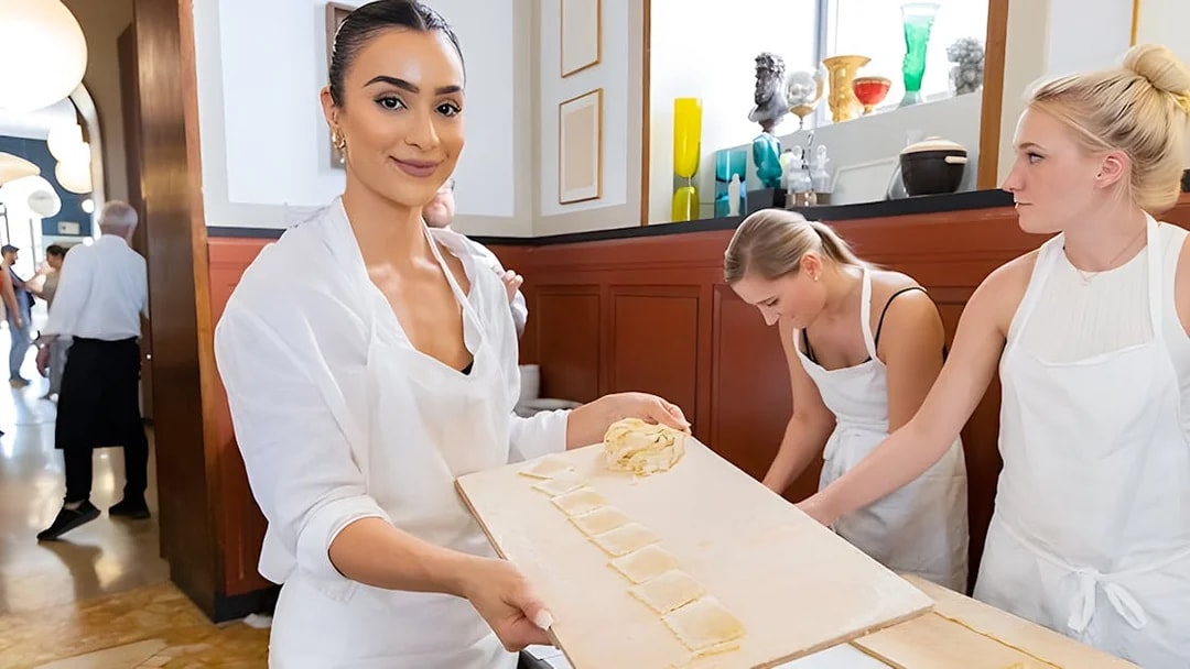 Participants making fettuccine in a Rome cooking class near Piazza Navona.