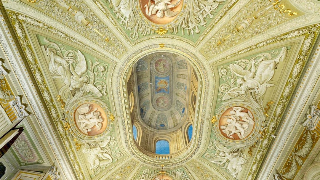 Doria Pamphilj Gallery ornate ceiling with frescoes and intricate carvings.