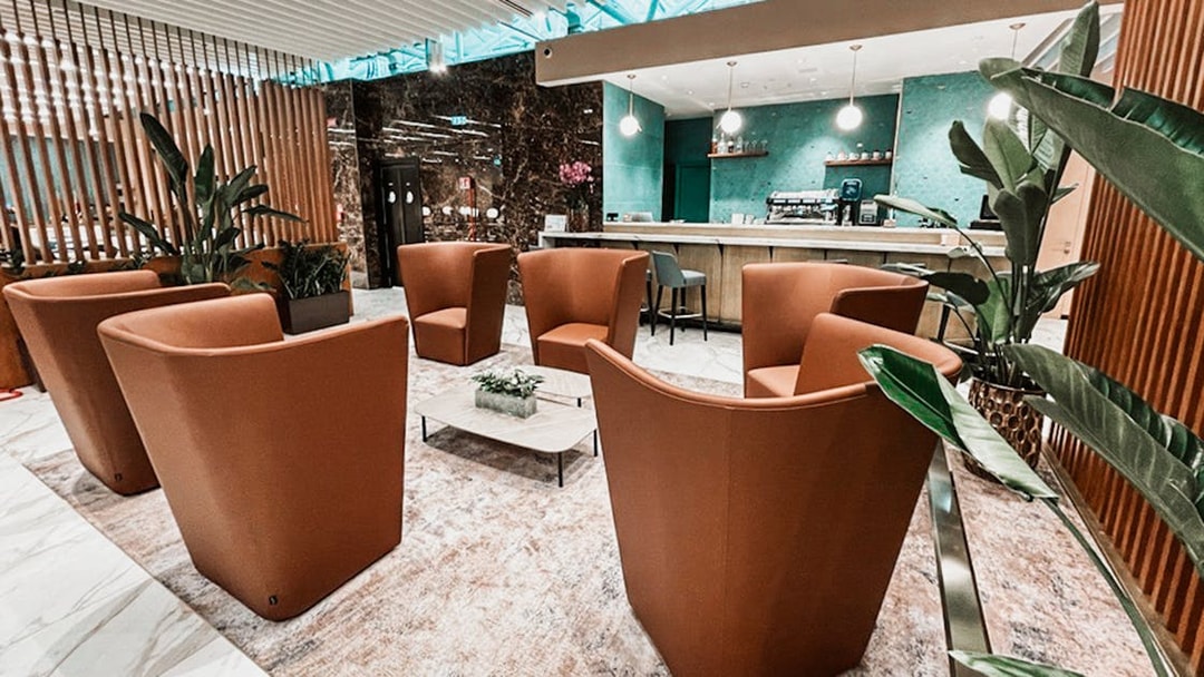 Premium lounge seating area at Rome Fiumicino Airport with modern decor and bar.
