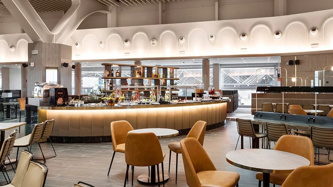 Premium lounge interior at Leonardo da Vinci-Fiumicino Airport with seating and bar area.