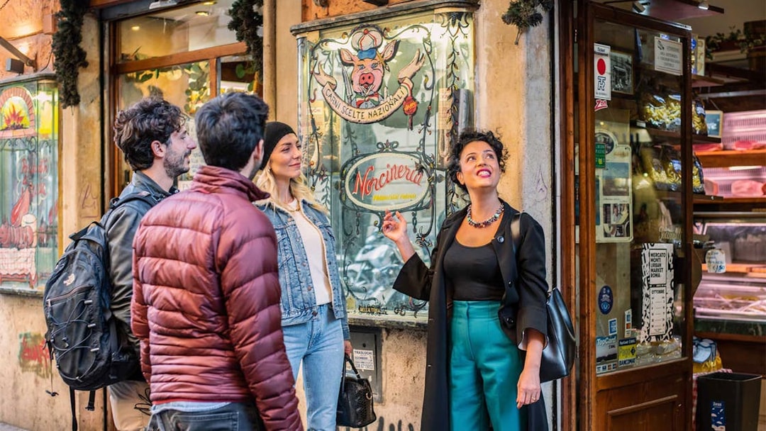 Tour group exploring a deli in Trastevere during a guided food and wine tour.