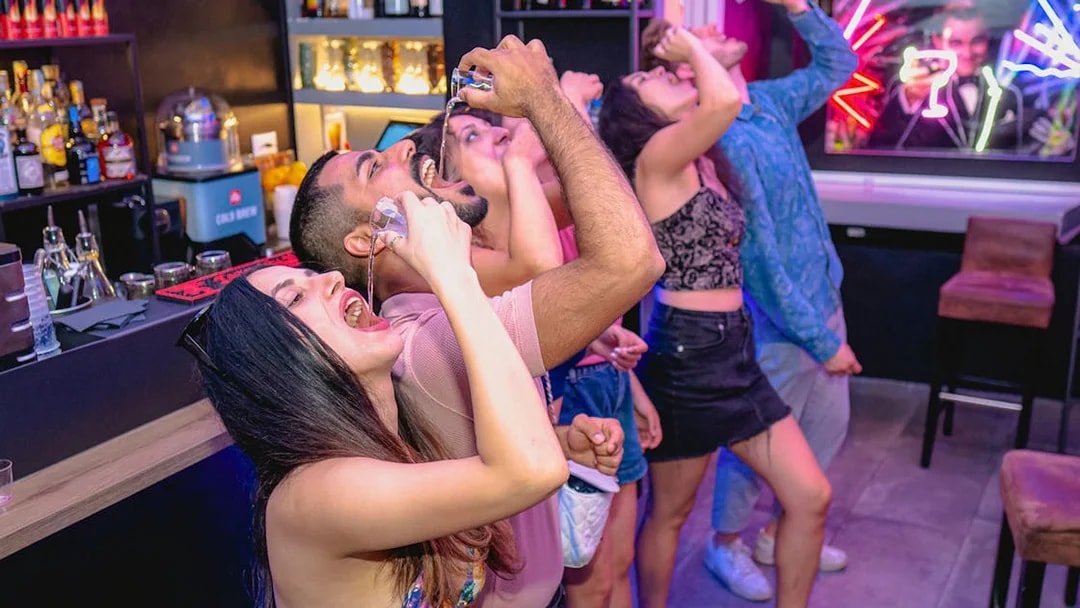 Group of friends enjoying drinks at a bar in Rome.