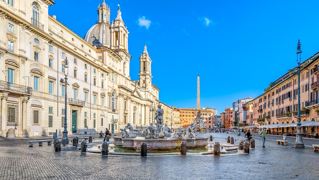 Piazza Navona in Rome featuring the Fountain of Neptune and surrounding architecture.