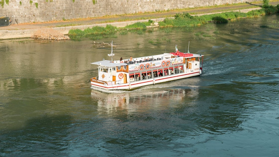 Hop-on hop-off river cruise boat on the Tiber River in Rome.