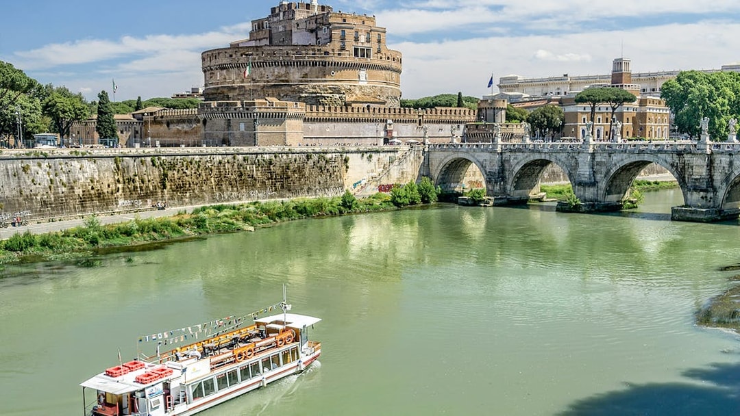 Cruise boat on the Tiber River near Castel Sant'Angelo, Rome.
