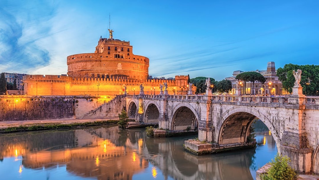 Castel Sant'Angelo and Ponte Sant'Angelo over Tiber River at night, Rome, Italy.