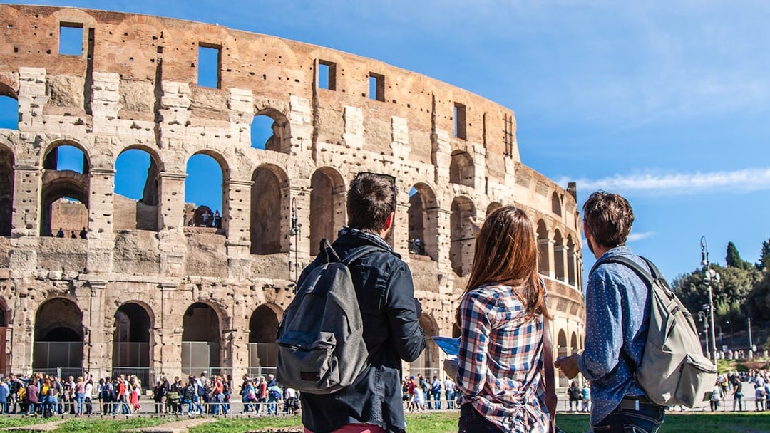 Tourists with backpacks exploring the Colosseum in Rome using the Rome Super Pass.