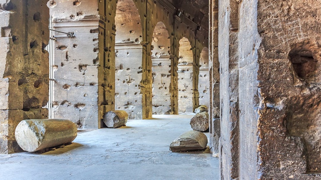 Colosseum underground passage with ancient stone columns in Rome, Italy.