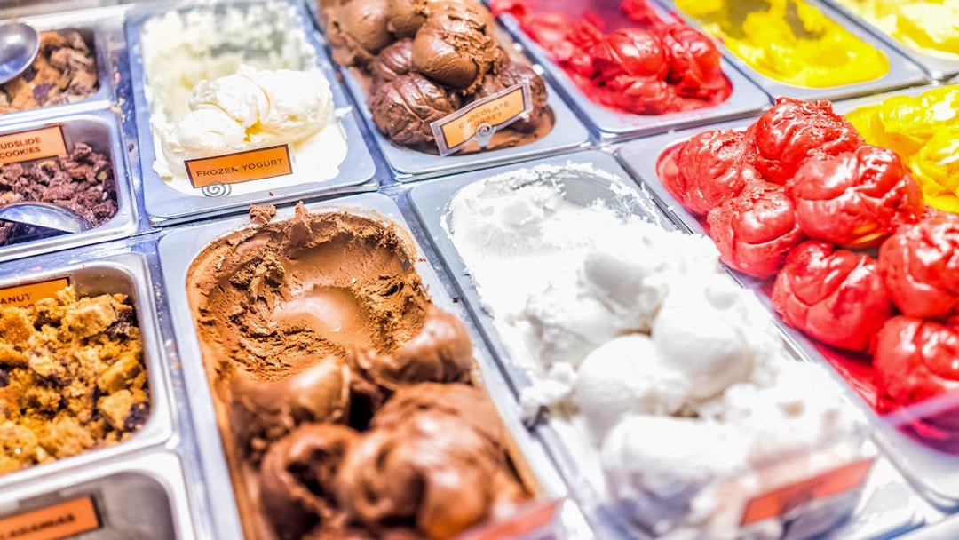 Gelato selection in a Rome shop, featuring chocolate, vanilla, and fruit flavors.