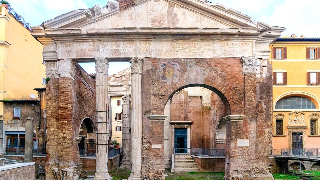 Portico di Ottavia ancient Roman ruins in Rome, Italy, featuring stone columns and archway.