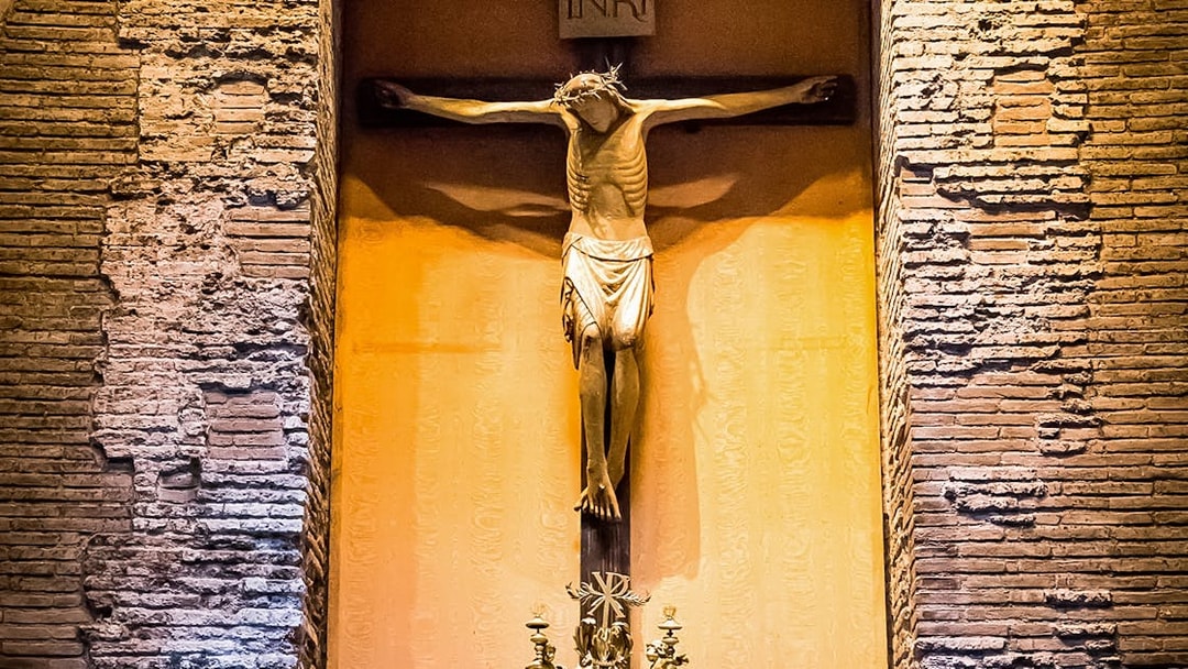 Crucifix inside the Pantheon, Rome, with detailed brick wall background.