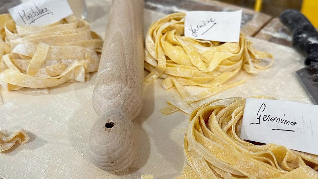 Fresh pasta dough with name tags at a cooking class in Rome.