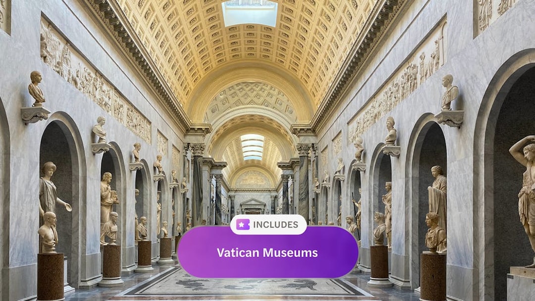 Vatican Museum hall with classical sculptures and ornate ceiling, Rome.